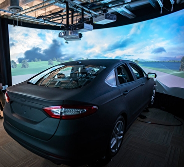 View of the HumanFirst driving simulator, including the car and the projection screen