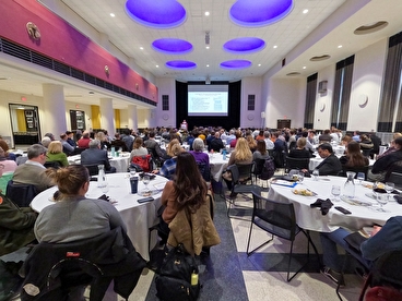 Attendees watching a keynote presentation at the 2023 CTS Research Conference