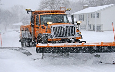 Snowplow plowing a snowy road