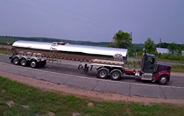 Camera still showing a semi truck on a roadway