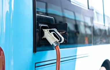 Electric bus plugged into a charging station