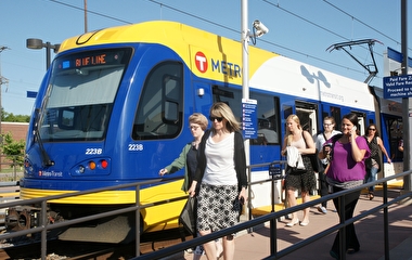 Blue Line train at a station with passengers disembarking