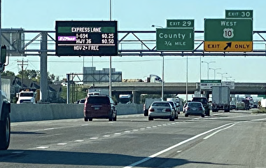 Freeway with an E-ZPass electronic sign overhead 
