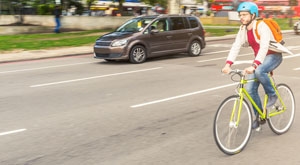 Man riding a bike alongside vehicle traffic