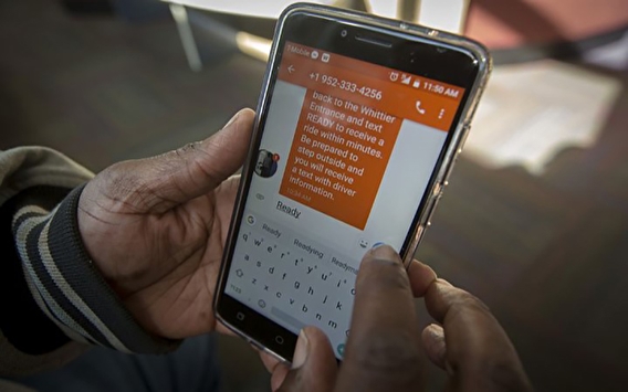 Hands holding a smartphone with a Hitch Health text message displayed