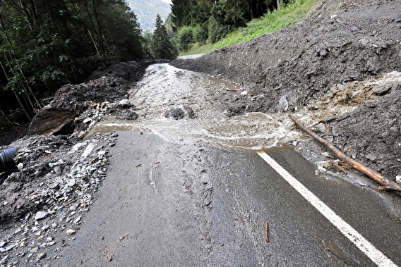 Paved road washed out by severe flooding
