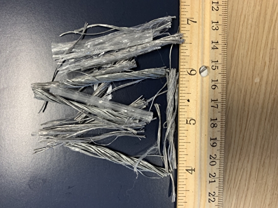 Fibers on a table next to a ruler
