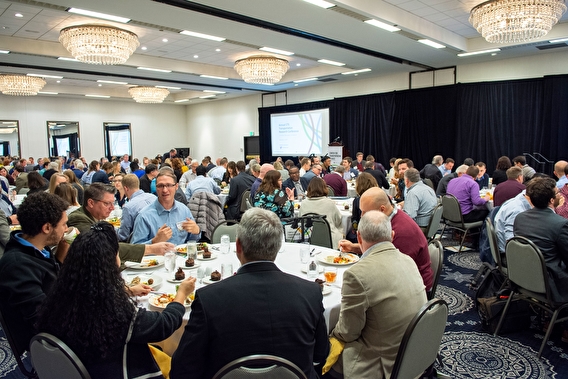 Attendees sitting around tables in the 2019 conference general session ballroom
