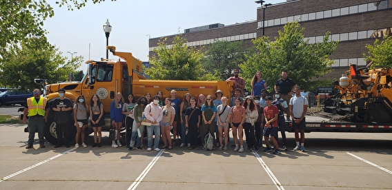 Students gathered in front of a dump truck at Discover STEM camp