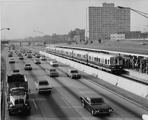 Historical image of a freeway in Chicago with a train running down the center