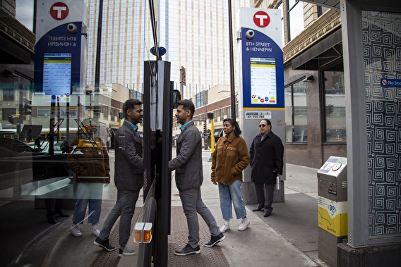 Passengers boarding a bus at a Metro Transit stop