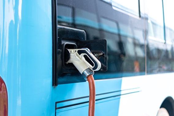 Bus plugged into an EV charging station