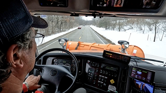A Dakota County snowplow driver in a vehicle equipped with the driver-assist system