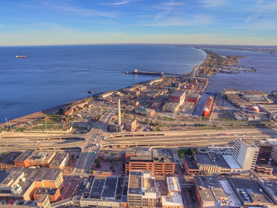 Aerial view of downtown Duluth, Canal Park, and I-35, with Lake Superior in the background