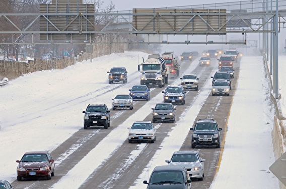 Traffic on a freeway partially covered with snow