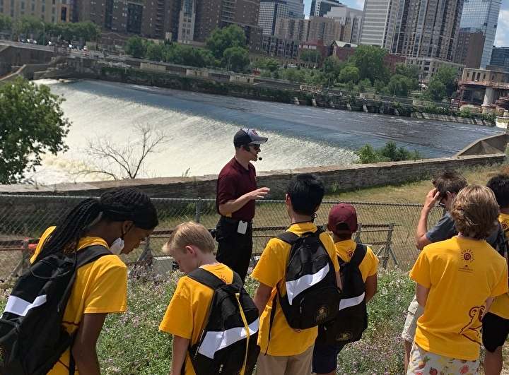 Students looking at St. Anthony Falls during a trip to SAFL.