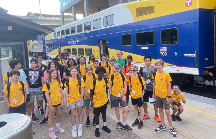 Students standing in a group in front of Metro Transit's Northstar train