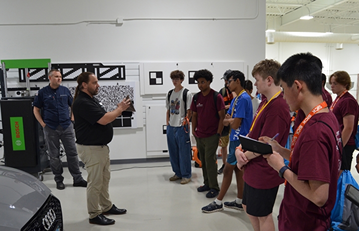 Campers touring the shop at Accelerated Vehicle Technology