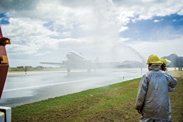 Firefighters spraying a plane on a runway