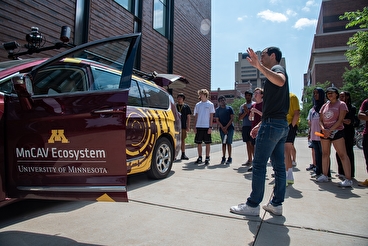 CAV campers gathers outside the research vehicle on campus