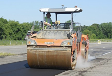 Machinery compacting asphalt