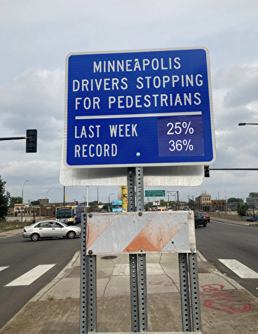 Sign displaying the percentage of drivers stopping for pedestrians in Minneapolis