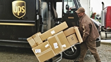 UPS worker loading packages into a UPS truck