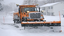 Snowplow plowing a snowy road